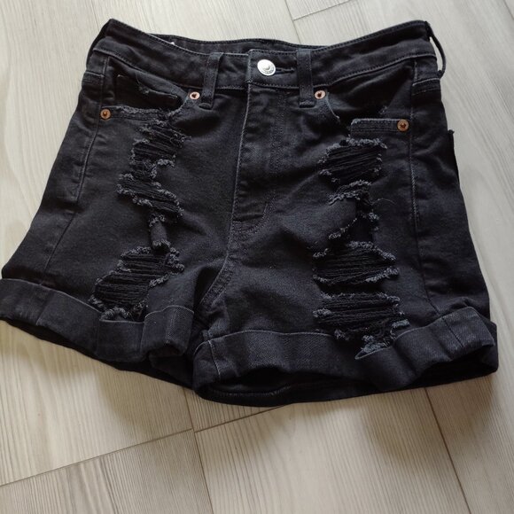 A pair of black American Eagle distressed pair of jean shorts in a size 0/25 - Picture 1 of 3